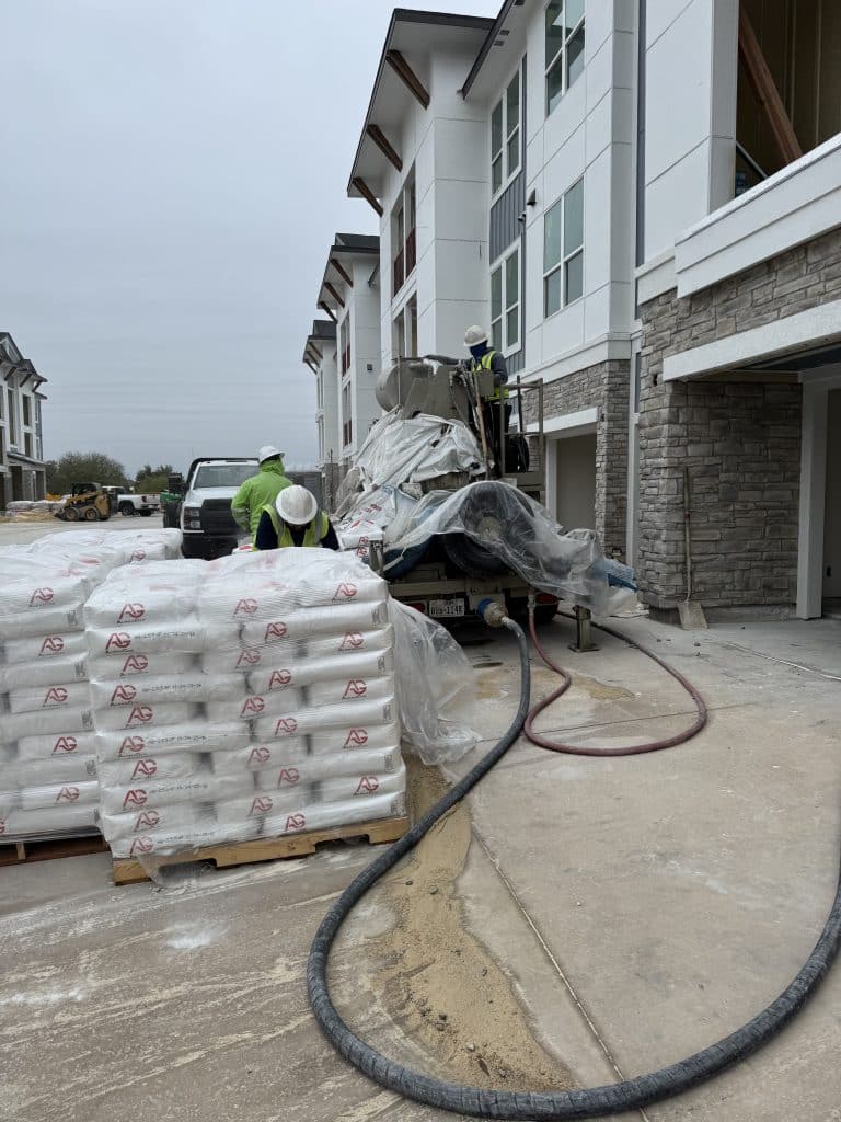 Gyp pump equipment with AlphaGyp bags on a jobsite